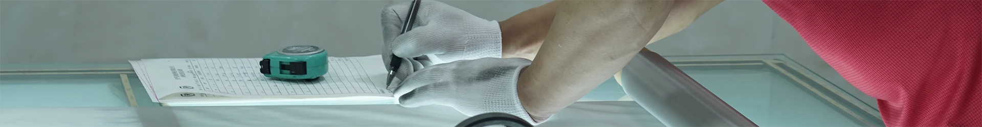 A worker is recoding the woven mesh test results.