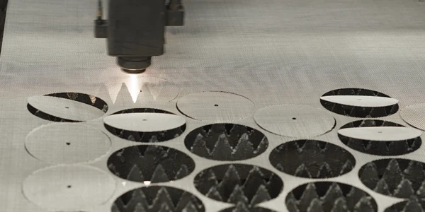 A laser cutting machine is cutting the woven mesh.