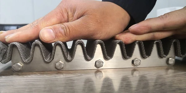 A person pressing woven mesh onto a pleating mold with their hand