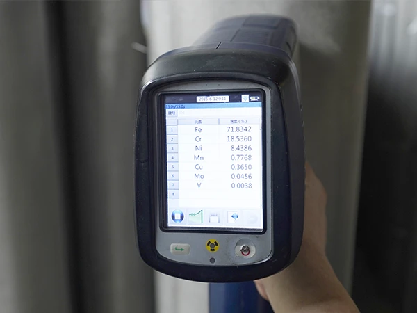 A tester is used to check the chemical composition of stainless steel woven mesh.