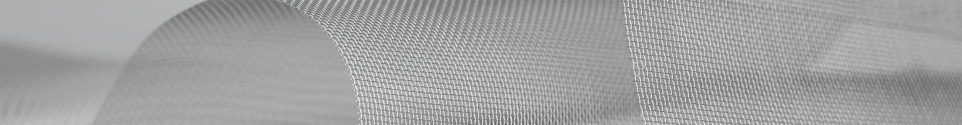 Stainless steel plain weave mesh is bent and placed on a flat surface.