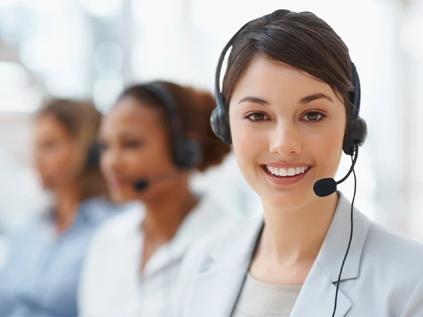 A person wearing a headset and smiling